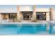 Striking pool with underwater lights, desert landscaping and view of the modern home's rear exterior at 6702 E Cholla St, Scottsdale, AZ 85254