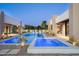 Stunning modern pool with water feature, colorful lighting, and views of the home at 6702 E Cholla St, Scottsdale, AZ 85254