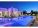 Stunning modern pool with water feature, colorful lighting, and views of the home at 6702 E Cholla St, Scottsdale, AZ 85254