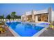 Modern pool with chaise lounges featuring colorful lighting and views of the home at 6702 E Cholla St, Scottsdale, AZ 85254