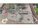 Aerial view of a backyard featuring an outdoor kitchen, fire pit, seating, and a unique water feature at 6712 W Northview Ave, Glendale, AZ 85303