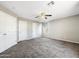 Spacious carpeted bedroom with two closets, neutral paint, ceiling fan, and ample room for furniture at 6712 W Northview Ave, Glendale, AZ 85303