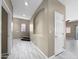 View of the hallway featuring tile floors, light gray walls, white doors, and an arched display space at 6712 W Northview Ave, Glendale, AZ 85303