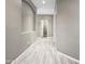 Inviting hallway with modern tile flooring, neutral paint, and recessed lighting showcases the home's layout at 6712 W Northview Ave, Glendale, AZ 85303