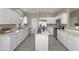 Modern kitchen featuring white cabinets, stainless steel appliances, quartz countertops, and a functional center island at 6712 W Northview Ave, Glendale, AZ 85303