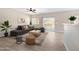 Cozy living room featuring tile floors, a comfortable sectional sofa, and sliding glass doors to the patio at 6712 W Northview Ave, Glendale, AZ 85303