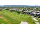 Expansive aerial view of a golf course community featuring lush green fairways and luxurious homes with mountain views at 7878 E Gainey Ranch Rd # 36, Scottsdale, AZ 85258