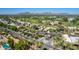 Scenic aerial view of a gated golf community with lush landscaping, palm trees, and mountain views in the background at 7878 E Gainey Ranch Rd # 36, Scottsdale, AZ 85258