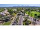 Gainey Ranch community entrance with lush landscaping and distant mountain views at 7878 E Gainey Ranch Rd # 36, Scottsdale, AZ 85258