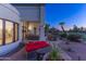Inviting back patio with comfortable seating and lush landscaping at twilight at 7878 E Gainey Ranch Rd # 36, Scottsdale, AZ 85258