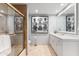 Bathroom featuring a glass shower door, vanity, toilet, framed picture, and neutral tile at 7878 E Gainey Ranch Rd # 36, Scottsdale, AZ 85258