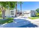 Beautiful home featuring desert landscaping, palm trees, and a circular driveway at 7878 E Gainey Ranch Rd # 36, Scottsdale, AZ 85258