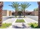 Modern community building exterior with desert landscaping, palm trees, and a welcoming entrance at 7878 E Gainey Ranch Rd # 36, Scottsdale, AZ 85258