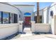 Inviting front entrance with a gated courtyard, desert landscaping, and red door at 7878 E Gainey Ranch Rd # 36, Scottsdale, AZ 85258