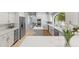 Bright kitchen featuring white cabinetry, stainless steel appliances and a central island with cooktop at 7878 E Gainey Ranch Rd # 36, Scottsdale, AZ 85258
