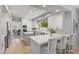 Modern kitchen with white cabinetry, a breakfast bar, and stainless-steel appliances at 7878 E Gainey Ranch Rd # 36, Scottsdale, AZ 85258