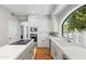 Bright kitchen with white cabinetry, stainless steel appliances, quartz countertops and a view to the backyard at 7878 E Gainey Ranch Rd # 36, Scottsdale, AZ 85258