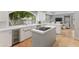 Bright kitchen with white cabinets, stainless steel appliances, quartz countertops and a view to the Gathering room at 7878 E Gainey Ranch Rd # 36, Scottsdale, AZ 85258