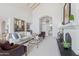 Bright living room featuring high ceilings, a fireplace, and a seamless flow to the entryway at 7878 E Gainey Ranch Rd # 36, Scottsdale, AZ 85258