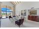 Bright living room with vaulted ceilings, large windows, comfortable seating, and stylish decor at 7878 E Gainey Ranch Rd # 36, Scottsdale, AZ 85258