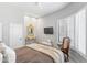 Bedroom featuring a tv, chair, ceiling fan, and plantation shutters on the window at 7878 E Gainey Ranch Rd # 36, Scottsdale, AZ 85258