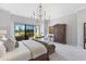Spacious main bedroom suite with elegant furnishings, chandelier, sitting area and access to balcony at 7878 E Gainey Ranch Rd # 36, Scottsdale, AZ 85258