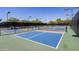 Outdoor pickleball courts with lighting and well-maintained fencing and landscaping at 7878 E Gainey Ranch Rd # 36, Scottsdale, AZ 85258