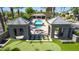 Overhead view of a community pool area with covered seating, putting green, and meticulously kept landscaping at 7878 E Gainey Ranch Rd # 36, Scottsdale, AZ 85258