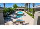 Stunning community pool area with a waterfall feature, spa, lounge chairs, and lush landscaping at 7878 E Gainey Ranch Rd # 36, Scottsdale, AZ 85258