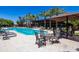 Outdoor pool area with lounge chairs and tables with palm trees in the background at 7878 E Gainey Ranch Rd # 36, Scottsdale, AZ 85258