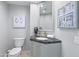 Stylish powder room with elegant vanity, granite countertop, and decorative wall art at 7878 E Gainey Ranch Rd # 36, Scottsdale, AZ 85258