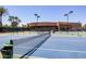 Tennis courts with the net in the foreground and well-maintained grounds in the background at 7878 E Gainey Ranch Rd # 36, Scottsdale, AZ 85258