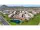 Gorgeous aerial view of community with pond, golf course, and surrounding cityscape and mountains at 7960 E Camelback Rd # 409, Scottsdale, AZ 85251