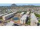 Aerial view of community showing lush landscaping, tennis courts, and nearby mountains at 7960 E Camelback Rd # 409, Scottsdale, AZ 85251