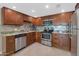 Updated kitchen with stainless steel appliances, custom cabinets, granite countertops, and stylish backsplash at 7960 E Camelback Rd # 409, Scottsdale, AZ 85251