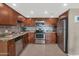 Modern kitchen with stainless steel appliances, updated countertops, and dark wood cabinetry at 7960 E Camelback Rd # 409, Scottsdale, AZ 85251