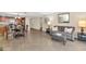 Open living room boasts tile flooring, comfortable seating, and seamless flow into the adjacent dining and kitchen areas at 7960 E Camelback Rd # 409, Scottsdale, AZ 85251