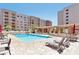 Beautiful community pool area featuring lounge chairs, covered patio, and well-maintained landscaping at 7960 E Camelback Rd # 409, Scottsdale, AZ 85251
