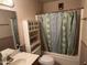 Cozy bathroom with a tub and shower combination featuring floral shower curtain at 8063 N 31St Ln, Phoenix, AZ 85051