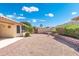 Beautiful backyard landscaping with rock covering and a red brick walkway at 8958 W Rosemonte Dr, Peoria, AZ 85382