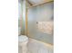 Bathroom shower featuring a glass door with gold trim, tiled floors, and a neutral color scheme at 8958 W Rosemonte Dr, Peoria, AZ 85382