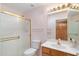 Cozy full bathroom featuring pink walls, shower, toilet, vanity, and gold hardware at 8958 W Rosemonte Dr, Peoria, AZ 85382