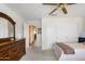 Neutral bedroom with large dresser, carpet, natural lighting, and a ceiling fan at 8958 W Rosemonte Dr, Peoria, AZ 85382