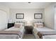 Comfortable bedroom with carpet, two beds, closet, and natural lighting at 8958 W Rosemonte Dr, Peoria, AZ 85382