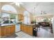 Open concept kitchen with tile flooring and updated appliances, seamlessly flowing to living space at 8958 W Rosemonte Dr, Peoria, AZ 85382