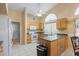 A vaulted ceiling and window brighten this eat-in kitchen featuring lots of cabinet space and tile floors at 8958 W Rosemonte Dr, Peoria, AZ 85382