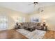 Spacious living room with hardwood floors, lots of seating, and natural lighting at 8958 W Rosemonte Dr, Peoria, AZ 85382