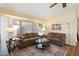 The living room features neutral walls, leather sofas, and bright natural light from a large window at 8958 W Rosemonte Dr, Peoria, AZ 85382