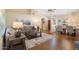 Open-concept living room with hardwood floors, large couch, and dining area nearby at 8958 W Rosemonte Dr, Peoria, AZ 85382