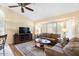 Inviting living room featuring a plush leather sofa set and a cozy decorative rug at 8958 W Rosemonte Dr, Peoria, AZ 85382